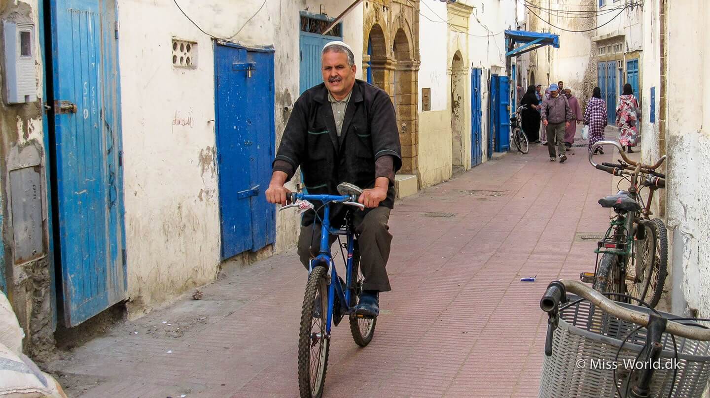 The Medina in Essaouira Morocco - Moroccan man on bike in the narrow streets of the medina